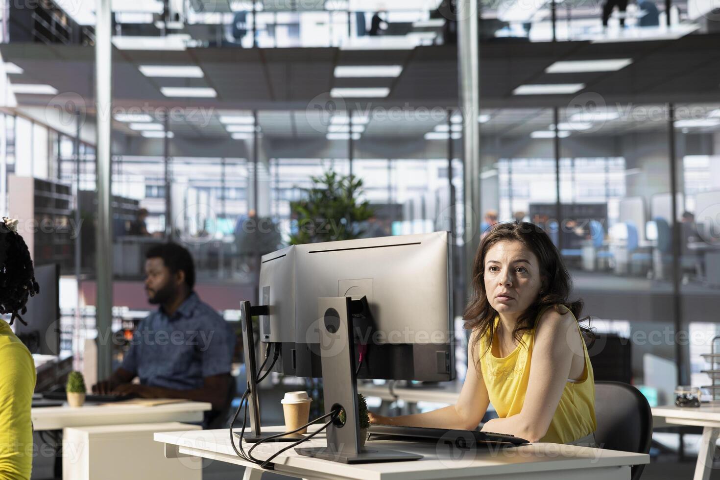 IT employees in office working at computer desks, testing and deploying programs and systems. Programmer and developers checking code on desktop PCs, solving tasks in workspace photo