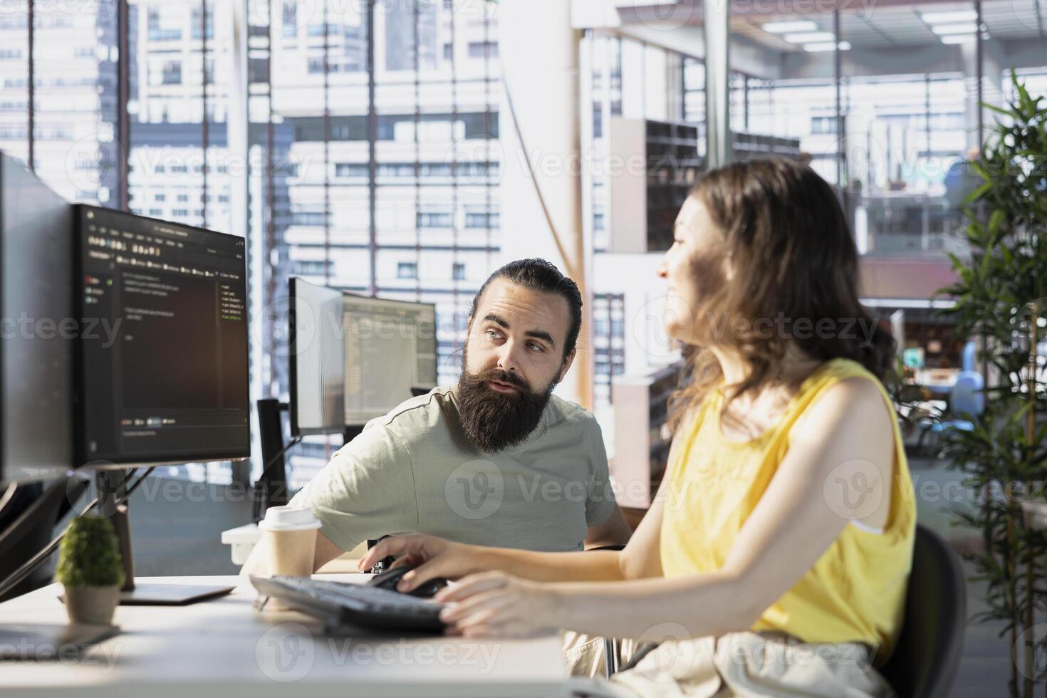 Programmer doing software debugging, asking for help from team leader in wheelchair. Employee fixing coding mistakes, being assisted by manager with disability in inclusive workplace photo
