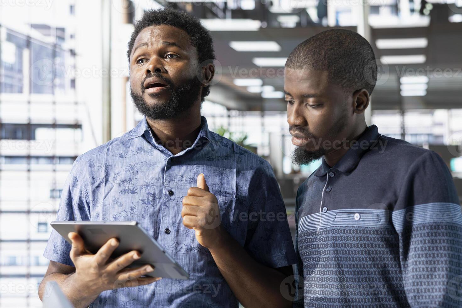 Team of office clerks working together on finishing project before impending deadline, auditing financial payroll reports in office. Teamworking coworkers looking at tablet, brainstorming ideas photo