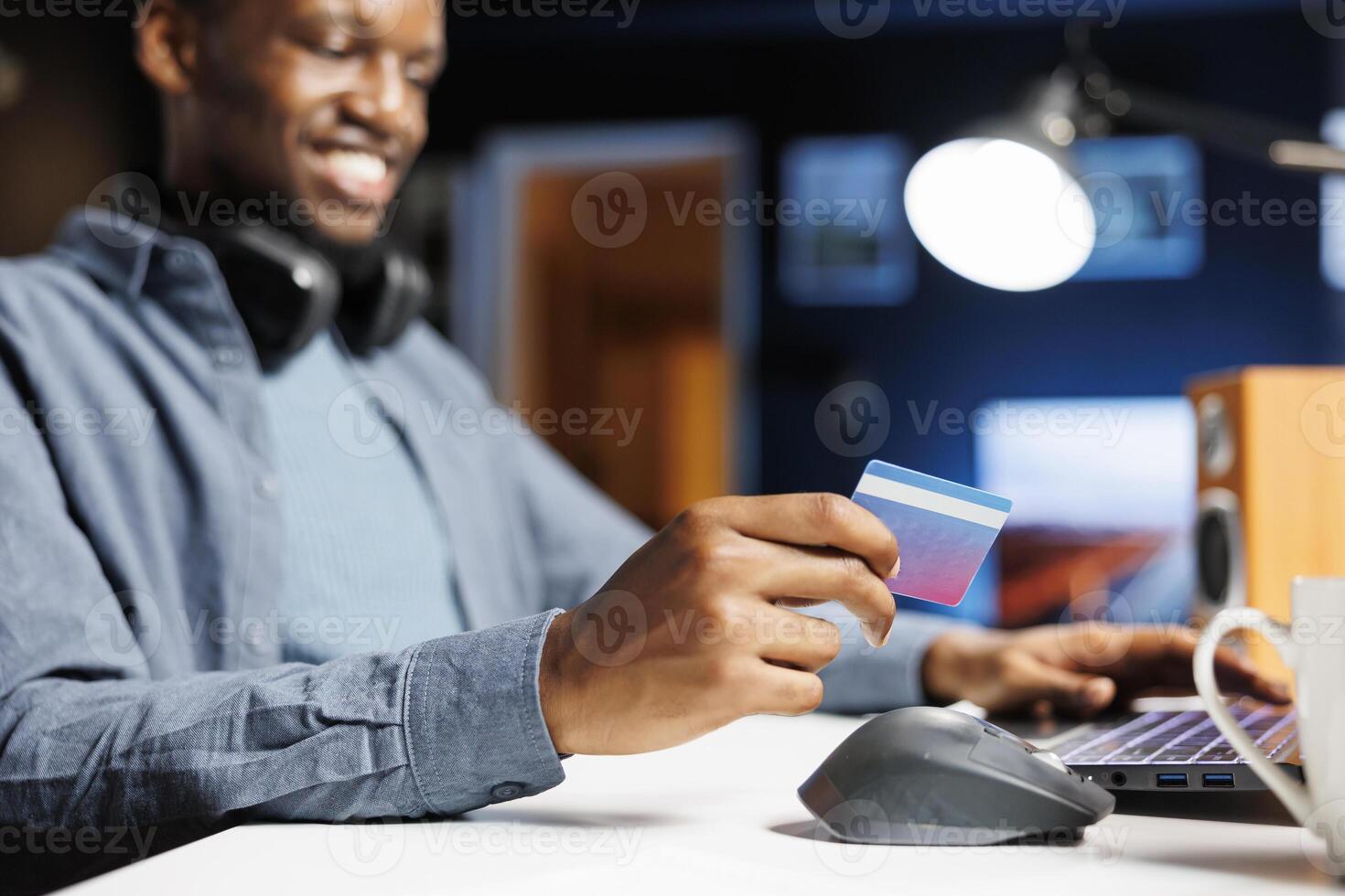 Guy purchasing products on electronic app with card, ordering apparel on internet during promotional season. Person feels satisfied as he shops and enters payment information for online transaction. photo