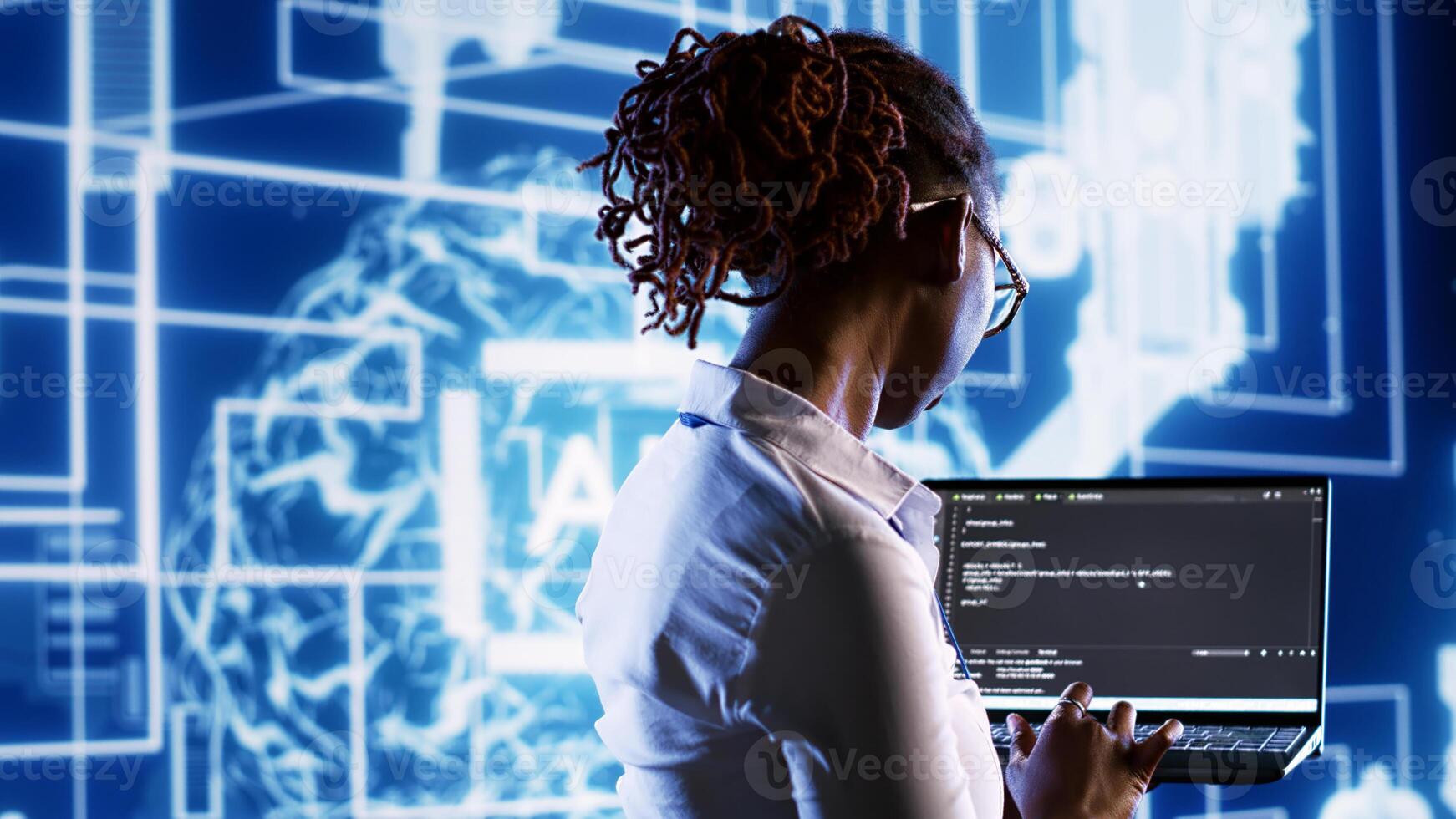 Inspector overseeing data center updating AI systems, writing intricate binary code scripts on laptop. Skilled IT practitioner using programming to upgrade artificial intelligence simulation model photo