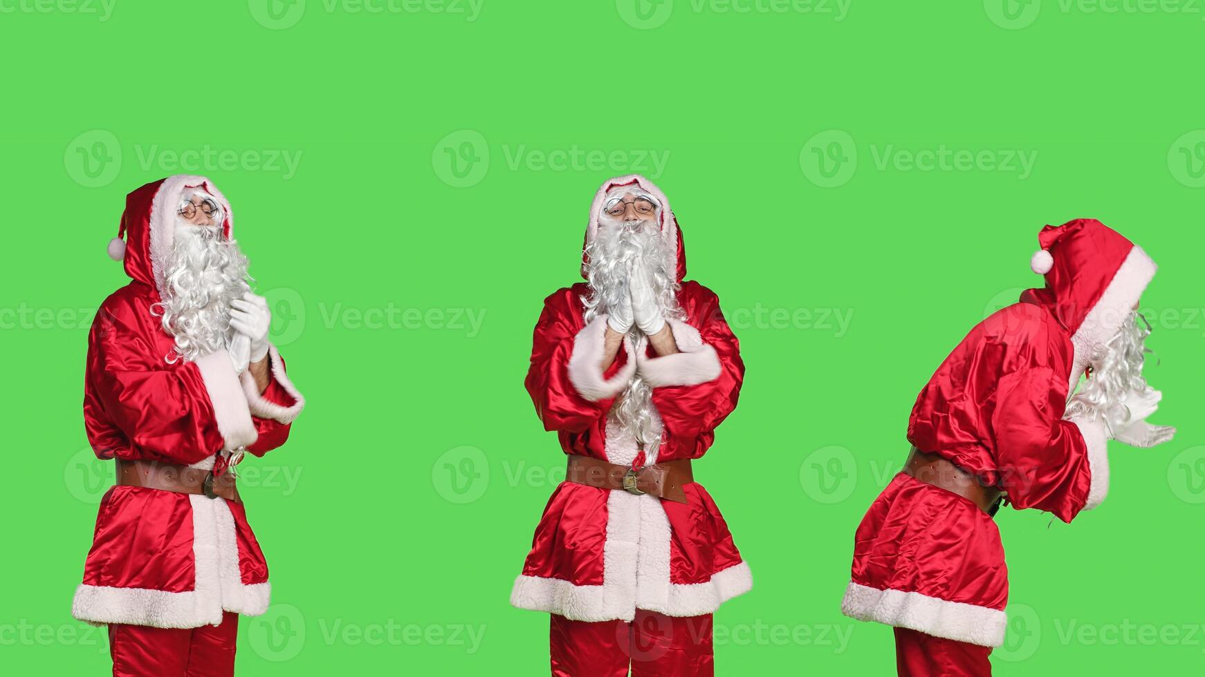Cheerful saint nick clapping hands, cheering for someone and applauding against greenscreen background. Young adult dressed as father christmas doing a standing ovation gesture, festive event. photo