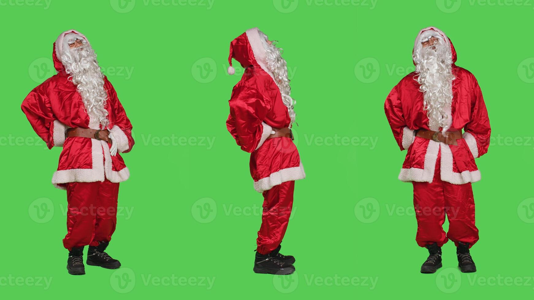 Old santa suffers from back pain in studio, feeling unwell standing over full body greenscreen backdrop. Man portraying saint nick dealing with hurt spine during christmas eve holidays. photo