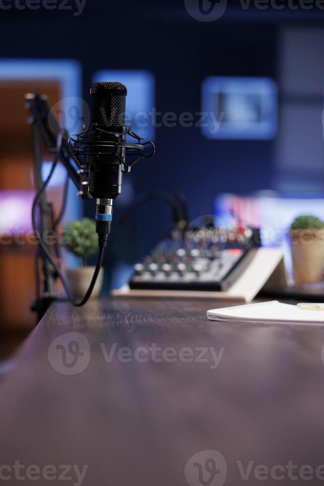 Podcast microphone for live streaming used to record content discussions for internet channels. Closeup of professional mic used for live online talk shows, broadcasted in a home studio. photo