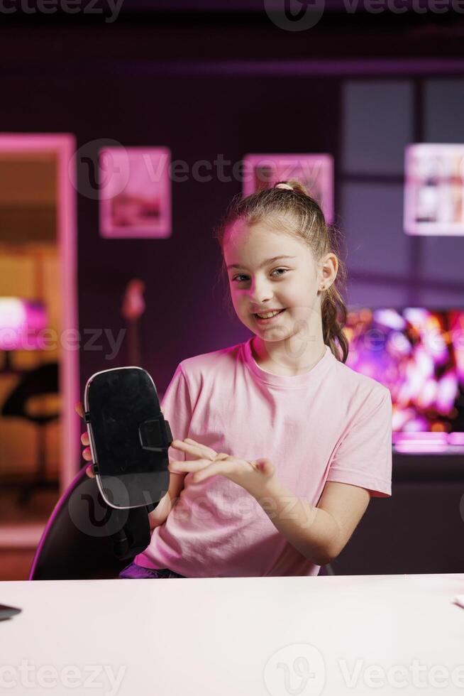 Gen Z media star filming about best virtual reality headset launched this year. Kid tech content creator recording VR goggles device review, assessing build quality and performance photo