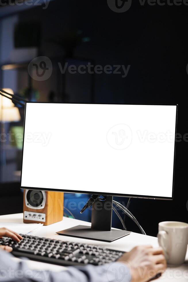 African american man staring at white screen on computer, working from home with blank empty copyspace display. Male web programmer looks at isolated chromakey layout on pc screen. photo