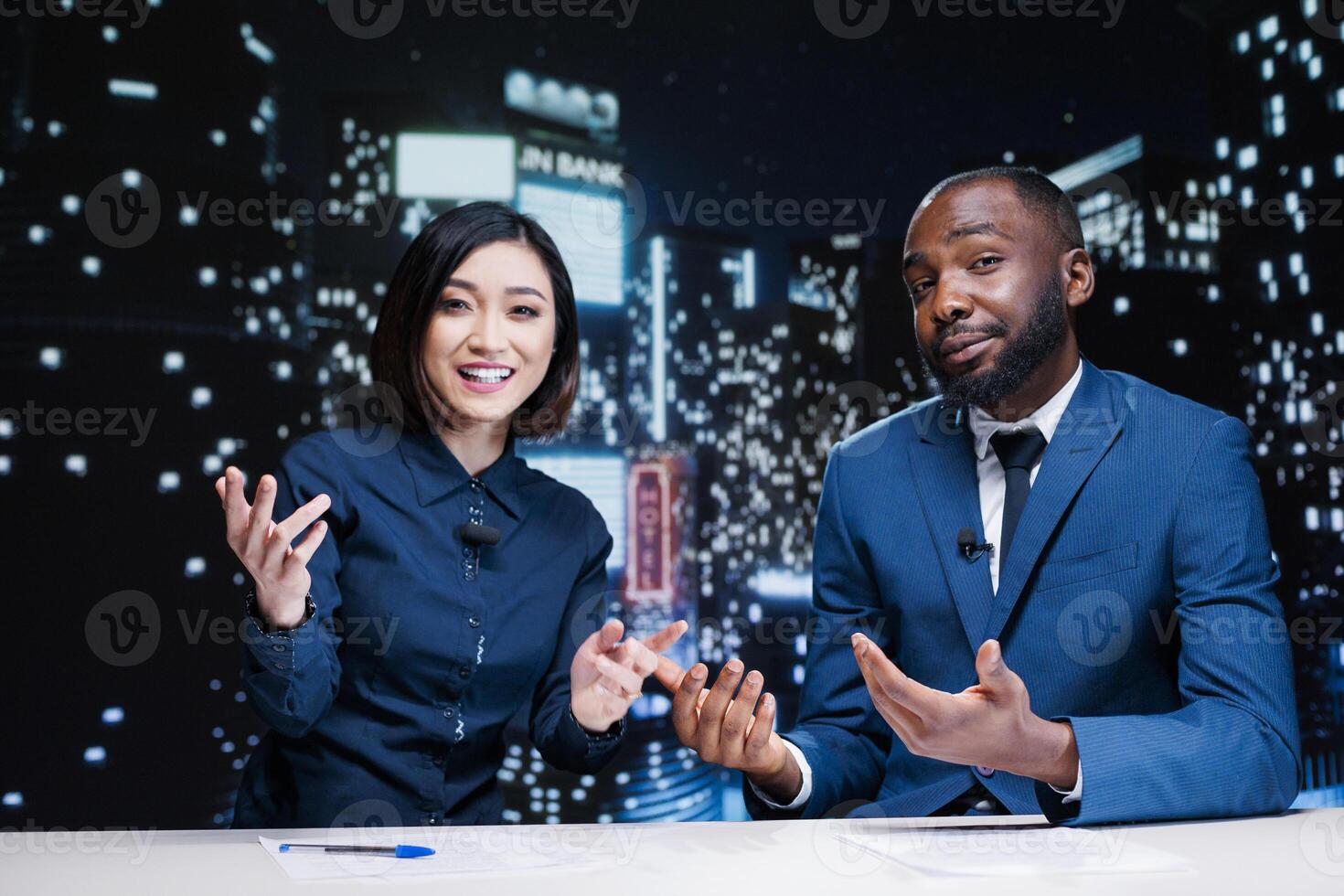 Team of newscasters on night tv show transmitting live information from media outlets and newspapers, global communications. Diverse reporters working on television network content. photo