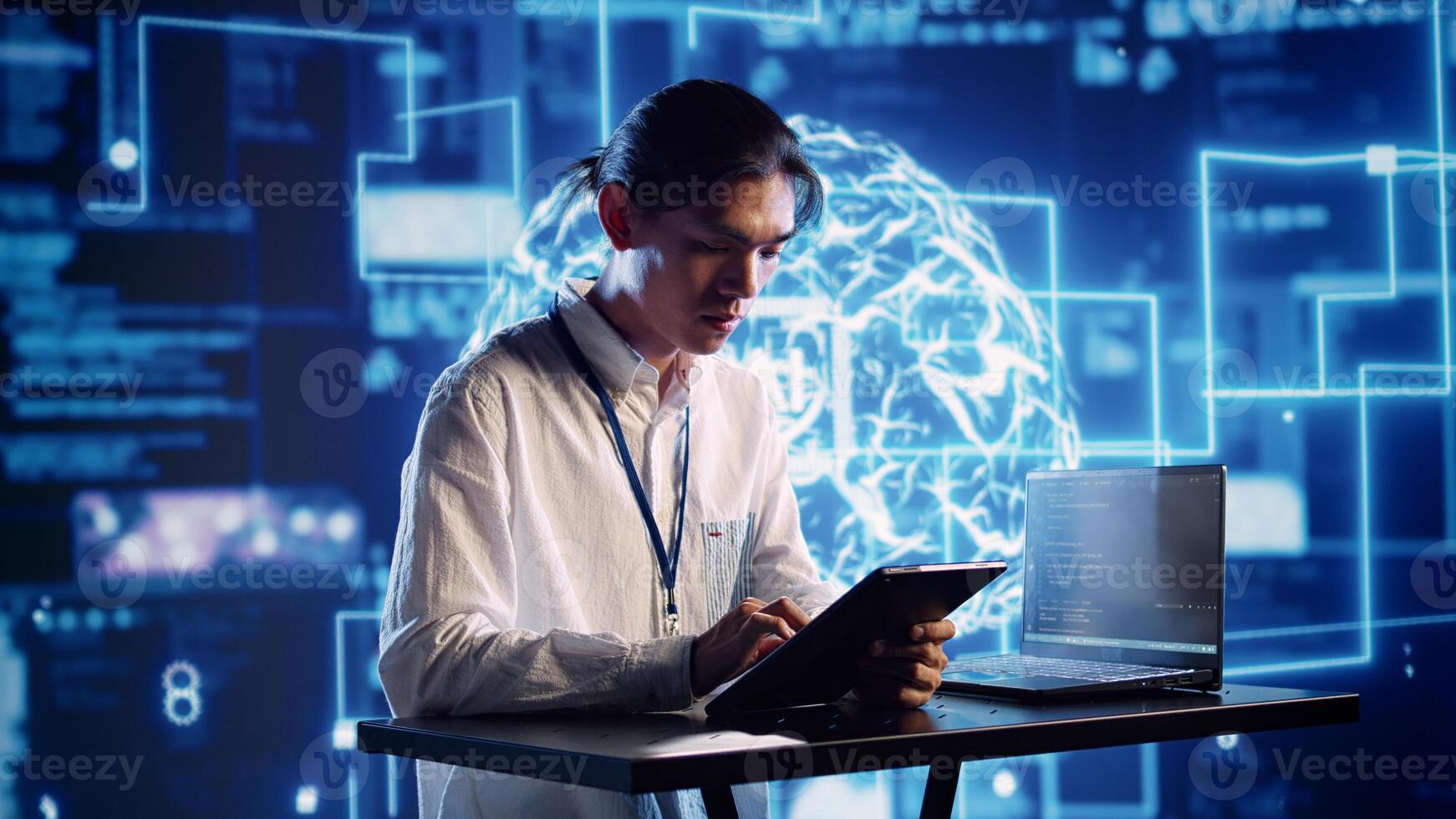 Productive engineer in high tech workspace uses artificial intelligence computing simulating human brain. Admin in server farm running operations on laptop with AI machine learning algorithms photo