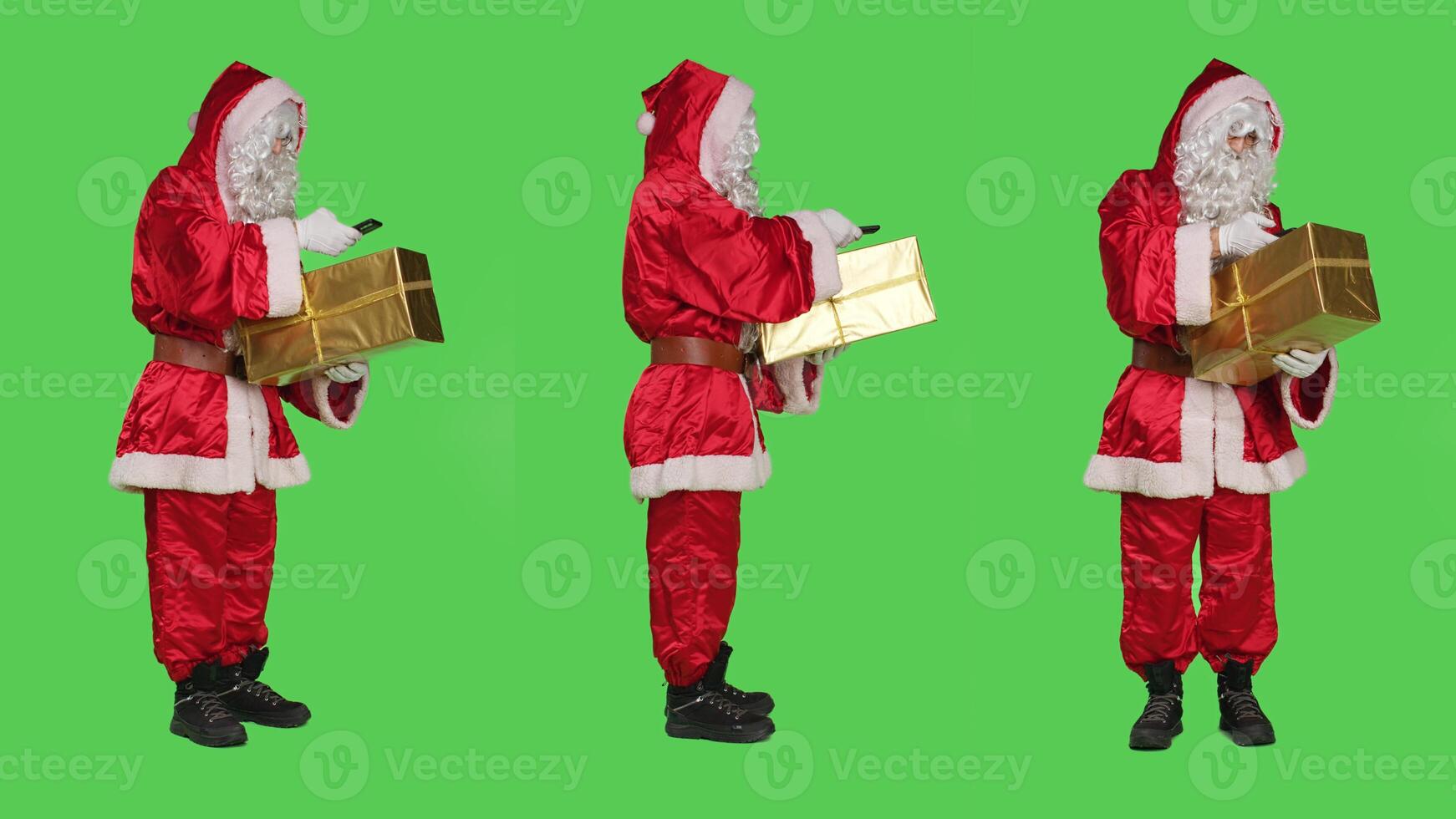 Santa claus taking picture of gift box over full body greenscreen backdrop, checking present before delivering to kids. Young man saint nick character with smartphone and packs. photo