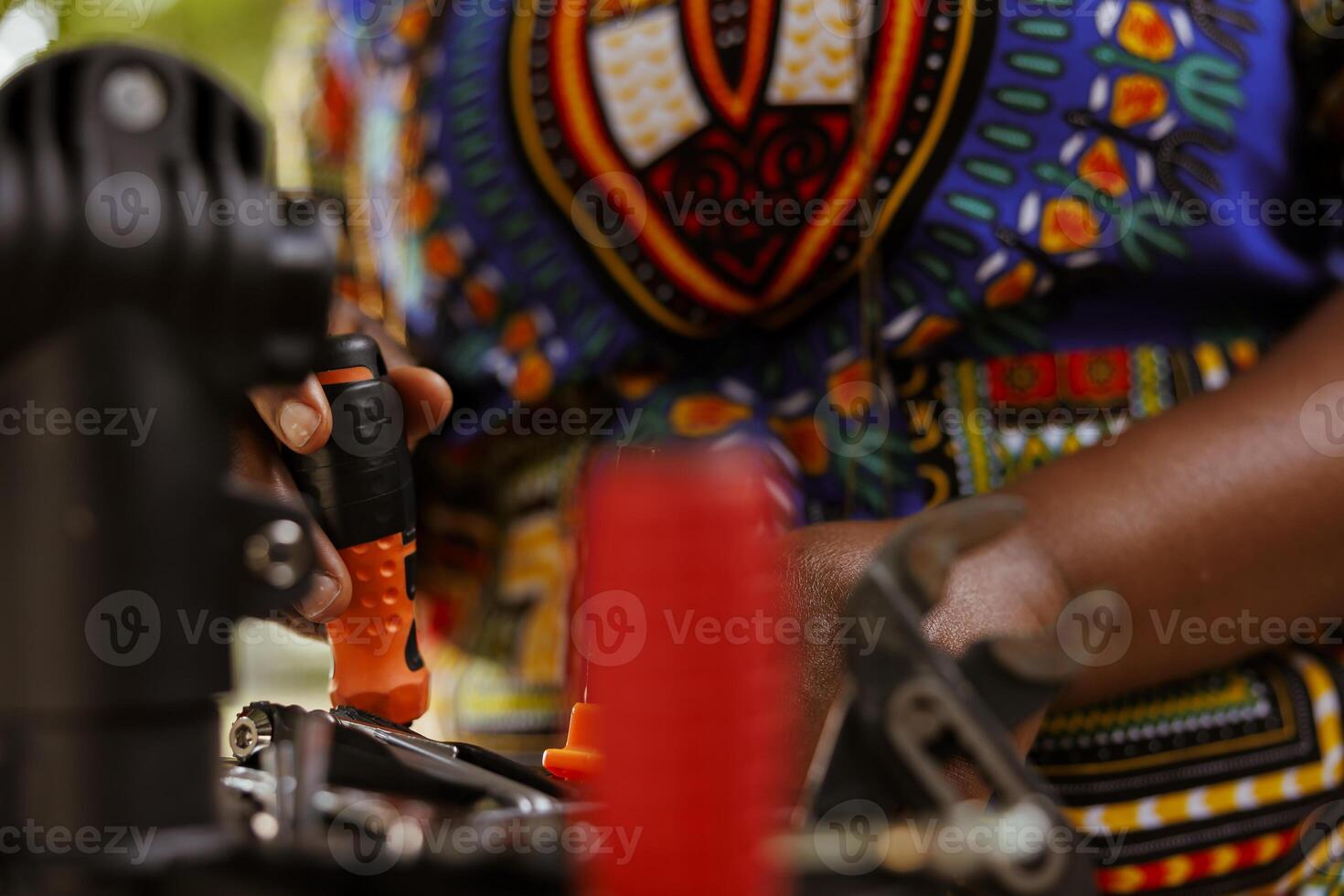 Up-close perspective of female african american hand organizing professional equipment for servicing bicycle. Sports-loving skilled individual examining and arranging specialized tools. photo