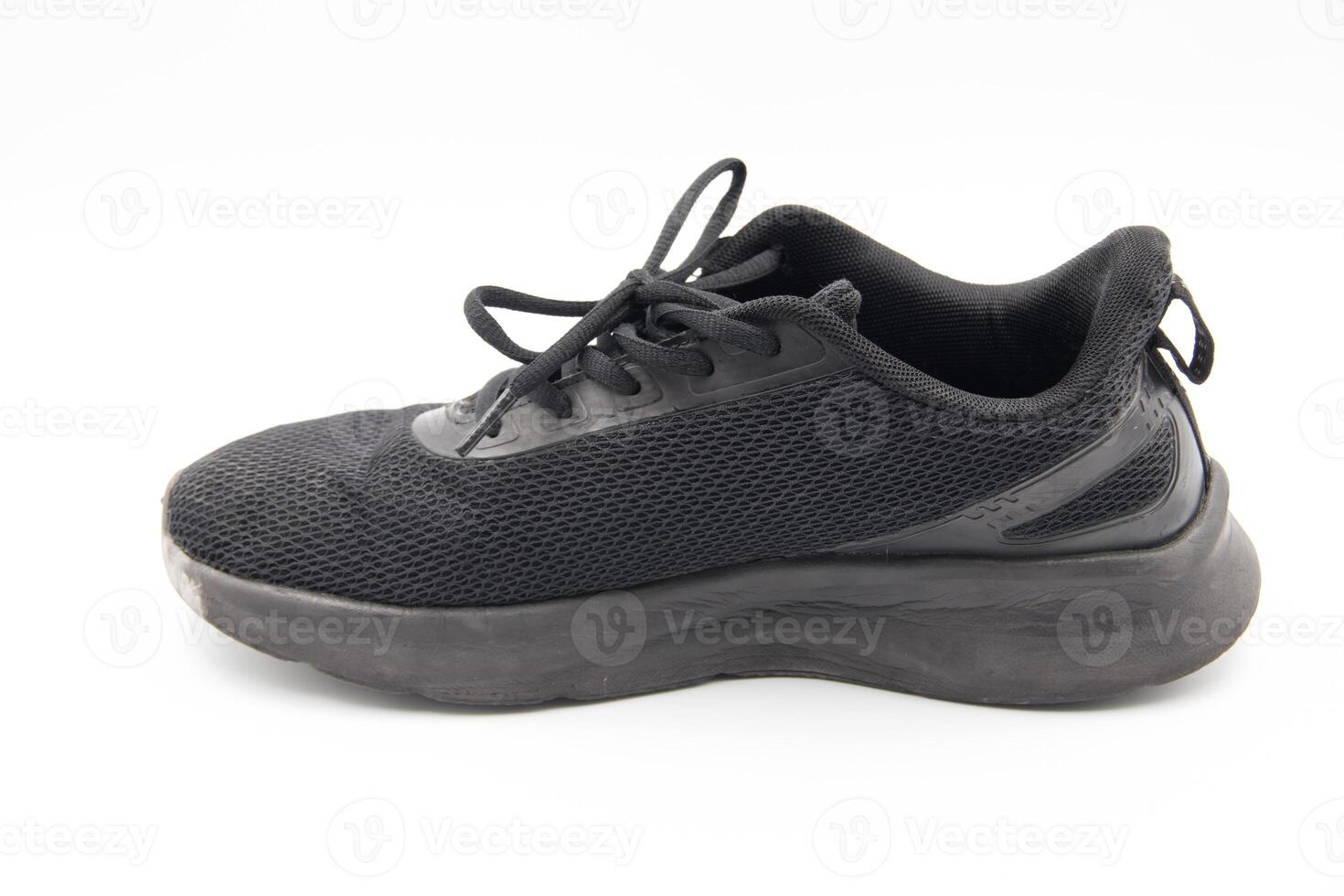 shoe sneaker on white background, close up of sneaker on white background, old black generic sneakers on white background. photo