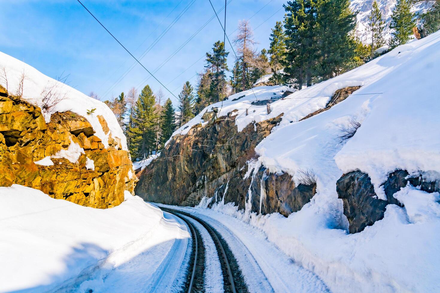 View of railway track and big rocks covered with snow photo