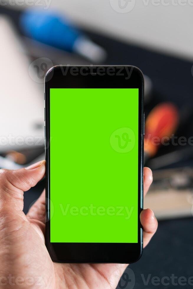 Smart phone with Green Screen in Hand photo
