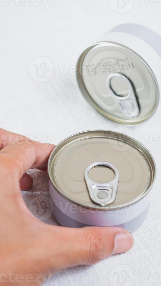 Hand Reaching for a Can with Pull-Tab Lid photo