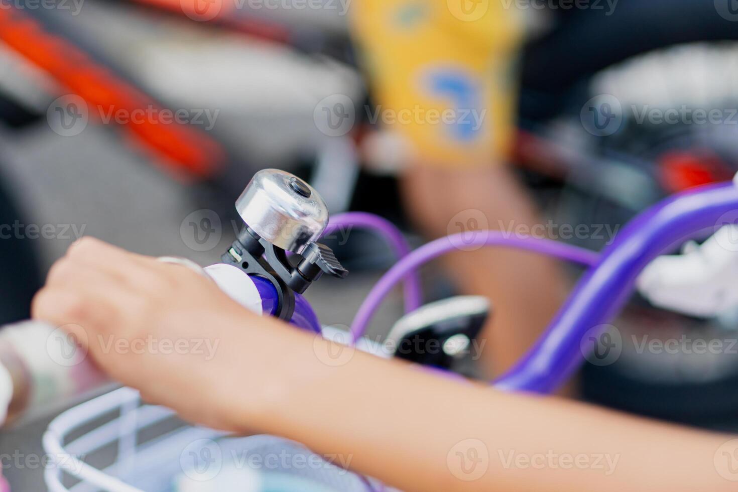 Close-Up of Child's Hand on Purple Bicycle Handlebar photo