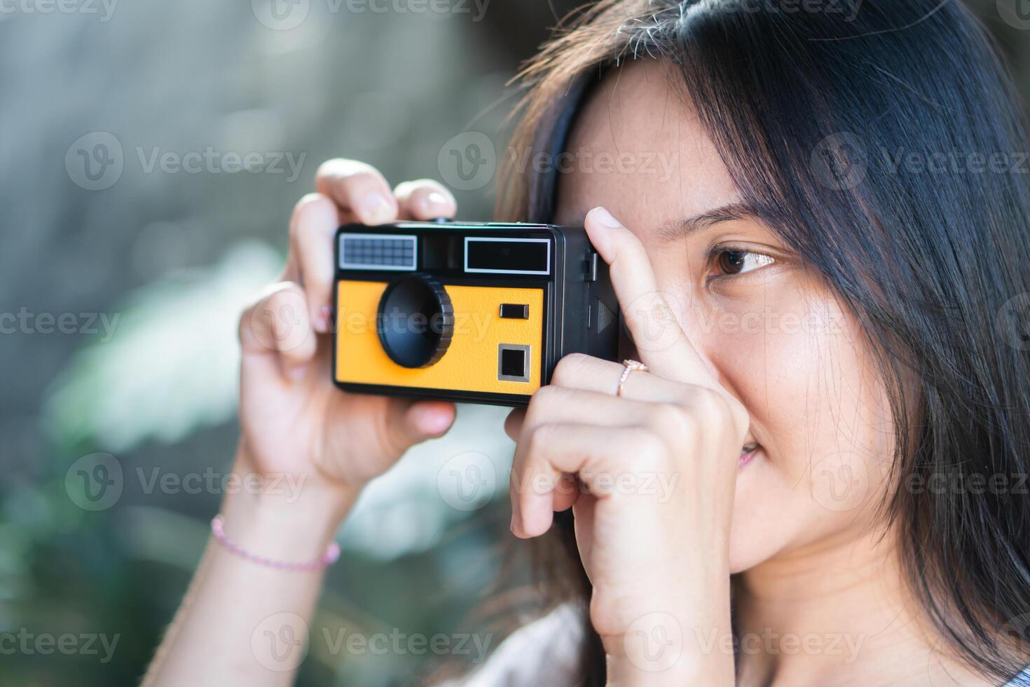 Young Woman Taking Photo with Vintage Camera