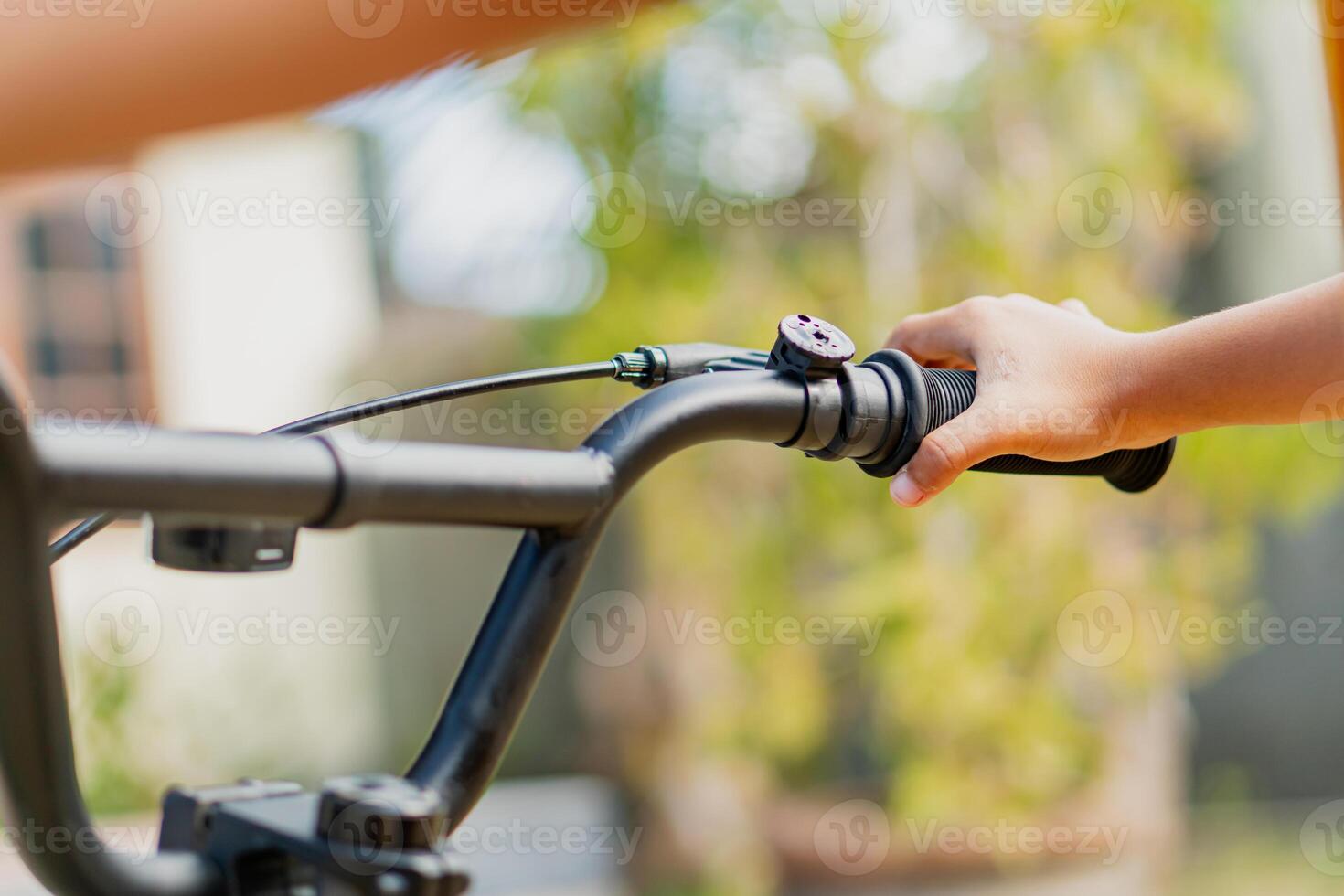 Close-Up of Hand Gripping Bicycle Handlebar Outdoors photo