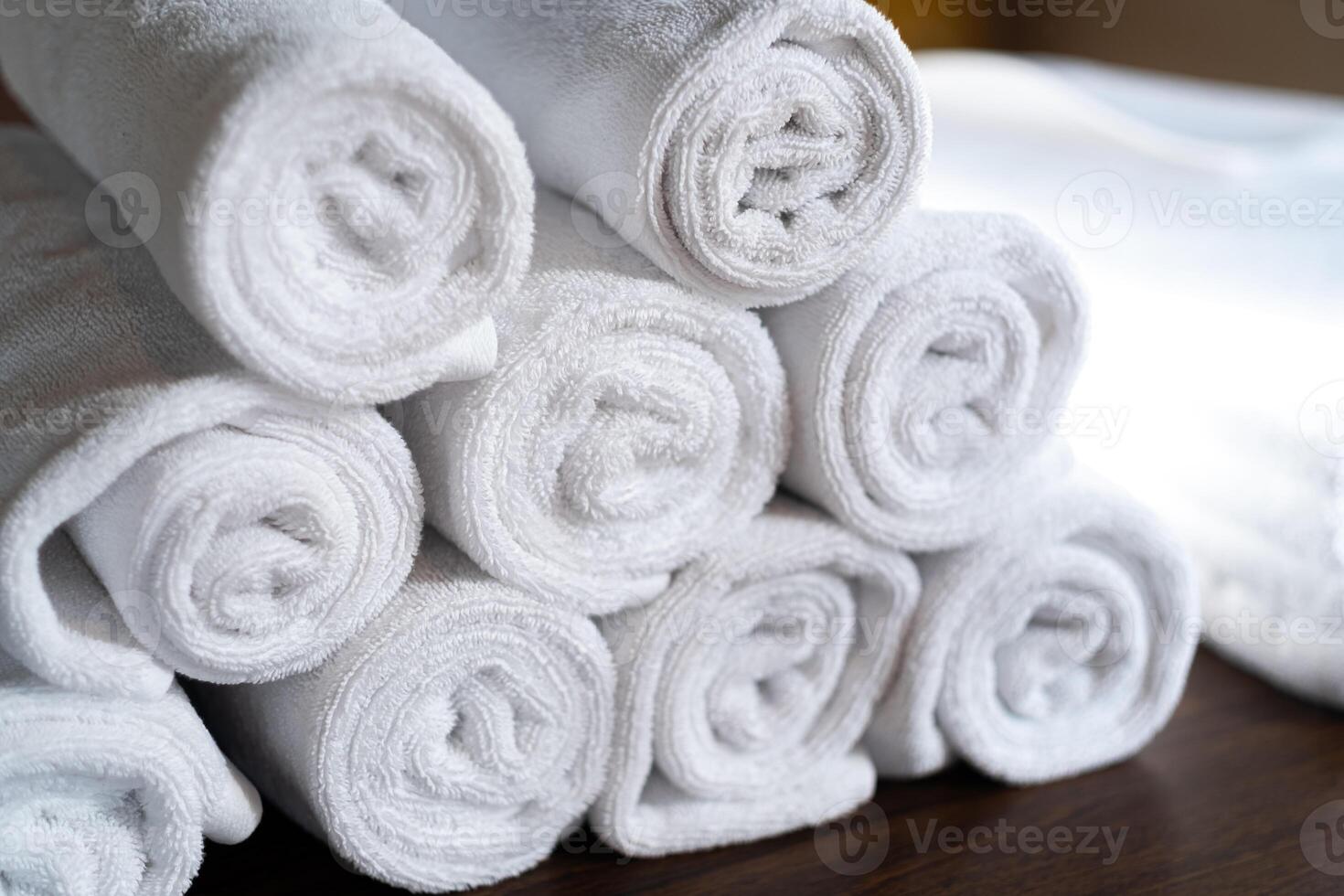 Neatly Stacked White Rolled Towels photo