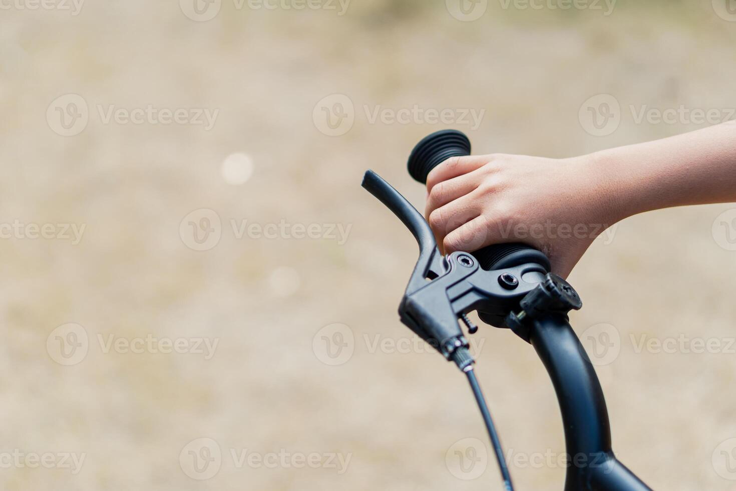 Close-Up of Hand Gripping Bicycle Handlebar Outdoors photo
