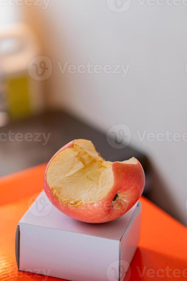 Bitten Red Apple on White Box photo
