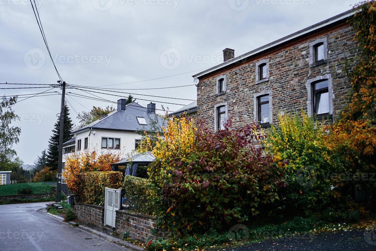 landscapes of an autumnal European village, Belgium, leaves colored by fall photo