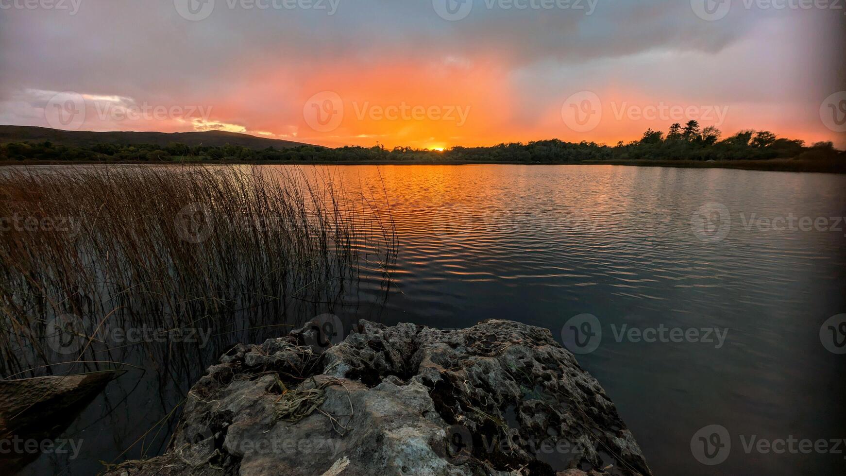 Beautiful orange sunset lakeside landscape scenery at Ross lake, Roscahill, Galway, Ireland, nature background photo