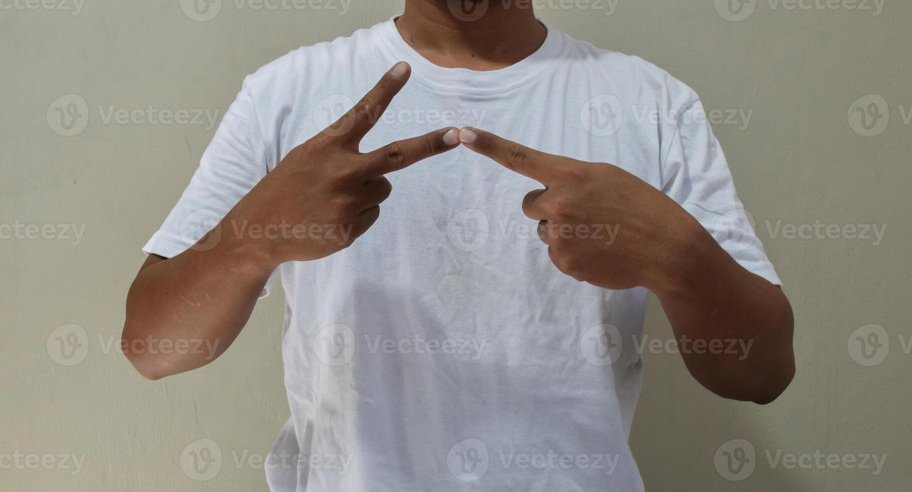 Young man learning and communicating in american sign language photo