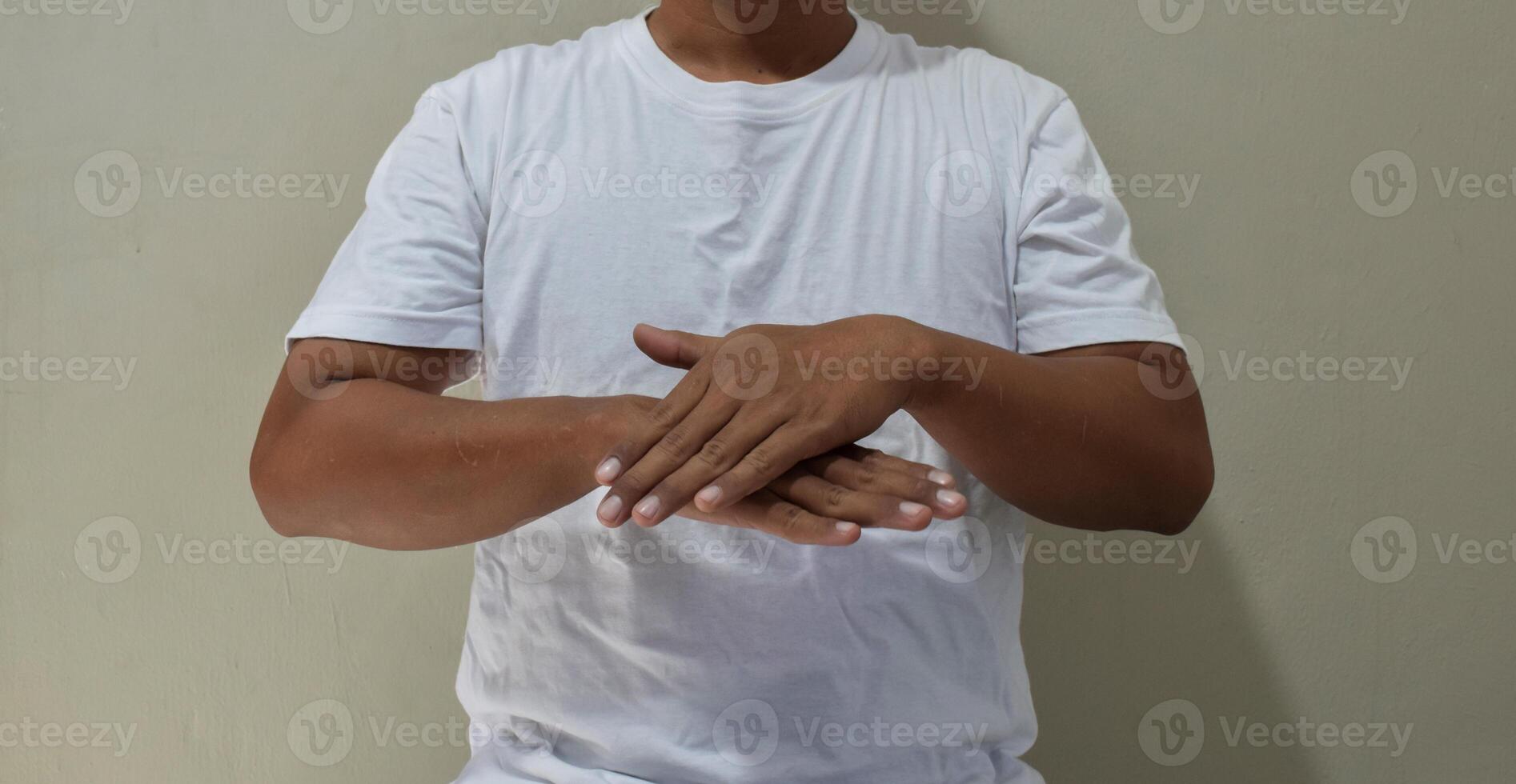 Young man showing slow please sign in asl, communication for deaf photo
