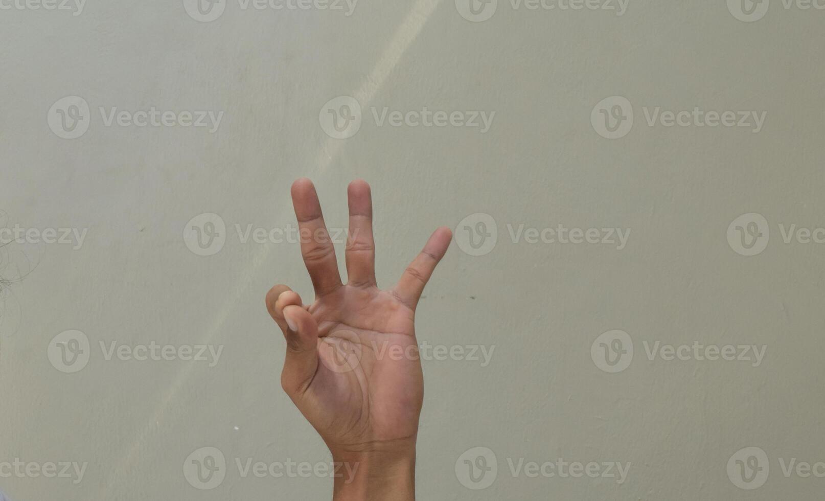 Man showing number nine in american sign language photo