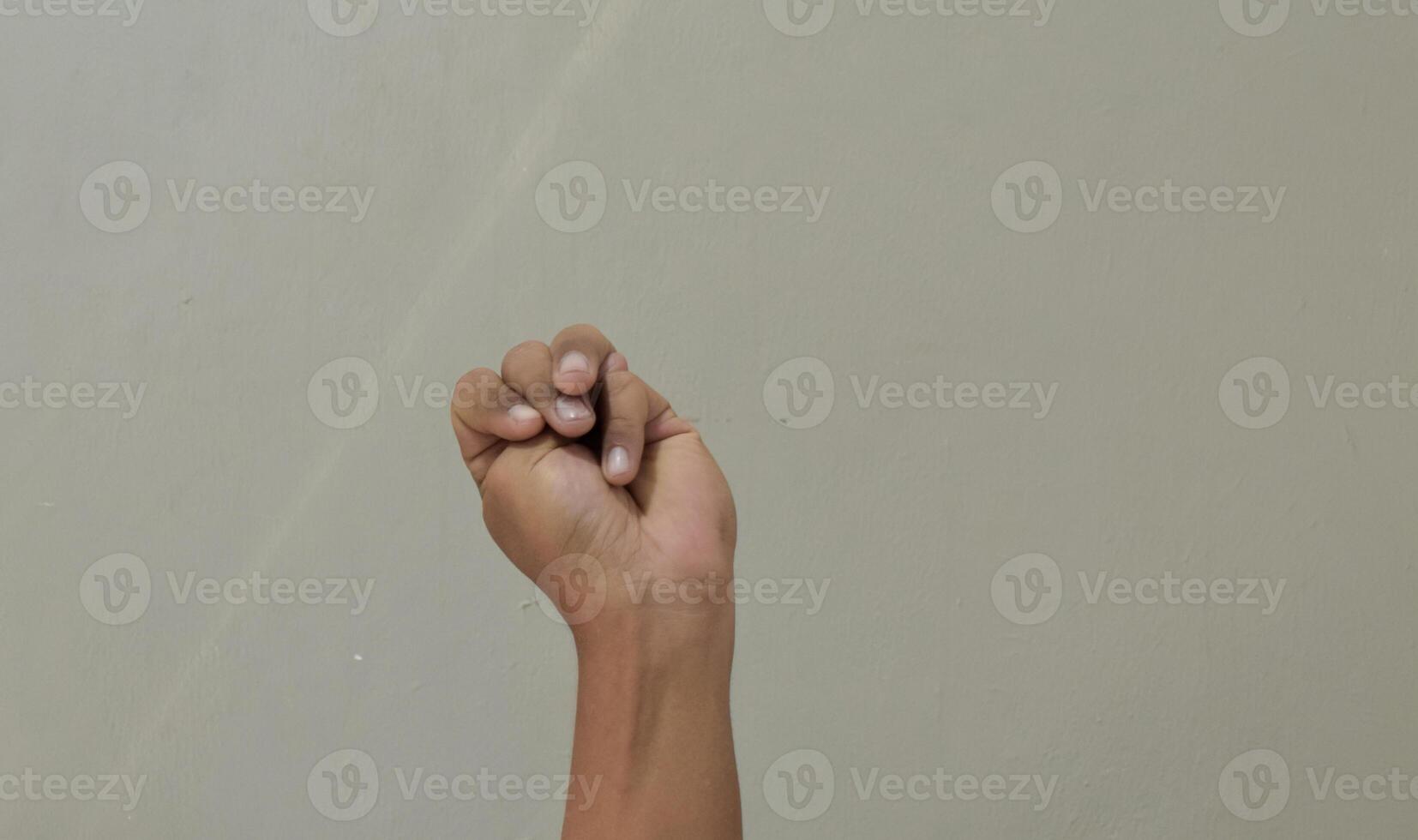 Finger spelling letter M in american sign language photo