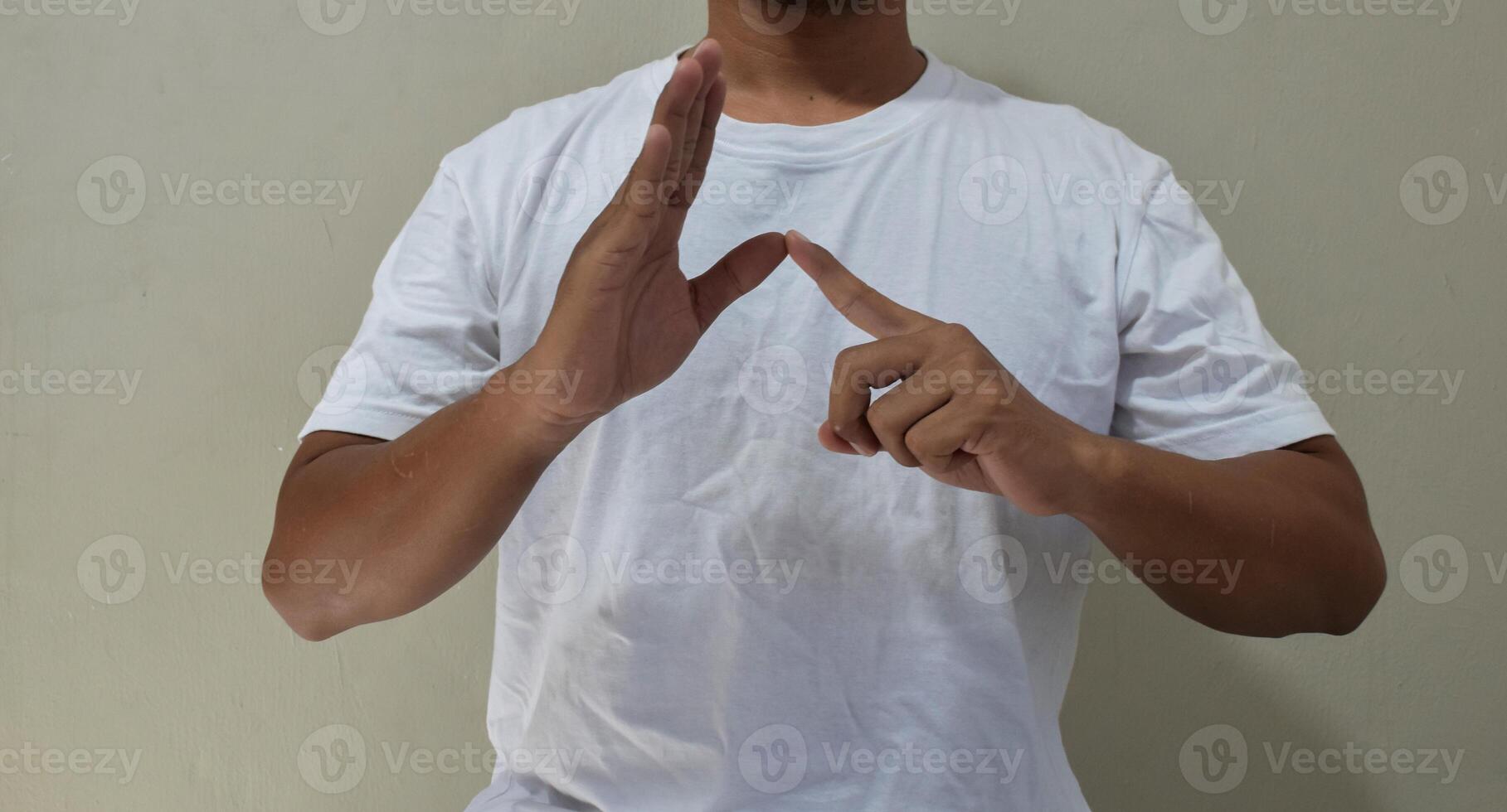 Young man shows sign language to talk. Hand gestures of people with hearing impairment photo