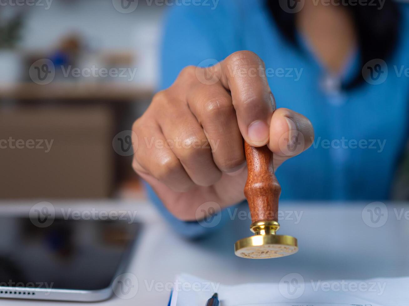 Approval stamp, Signing on business partner paper to success, Businesswoman hand stamping with approved stamp on text approved document at desk, Validates and manages business documents photo