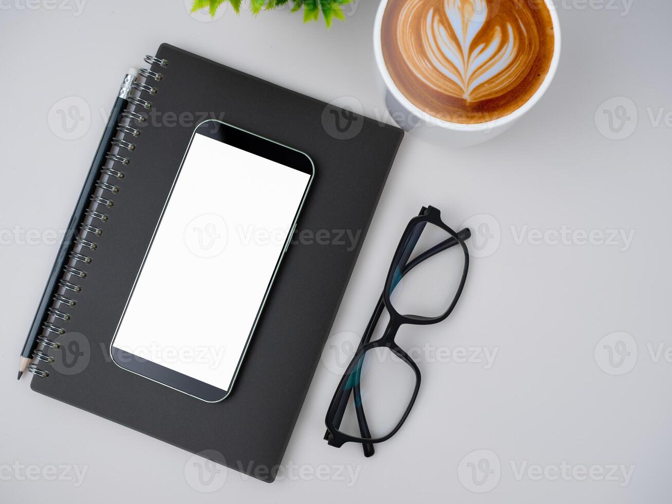 Top view of mock up modern workspace with blank screen smartphone, keyboard. Office situation with keyboard and accessories isolated on white. Copy space, Flat lay. photo