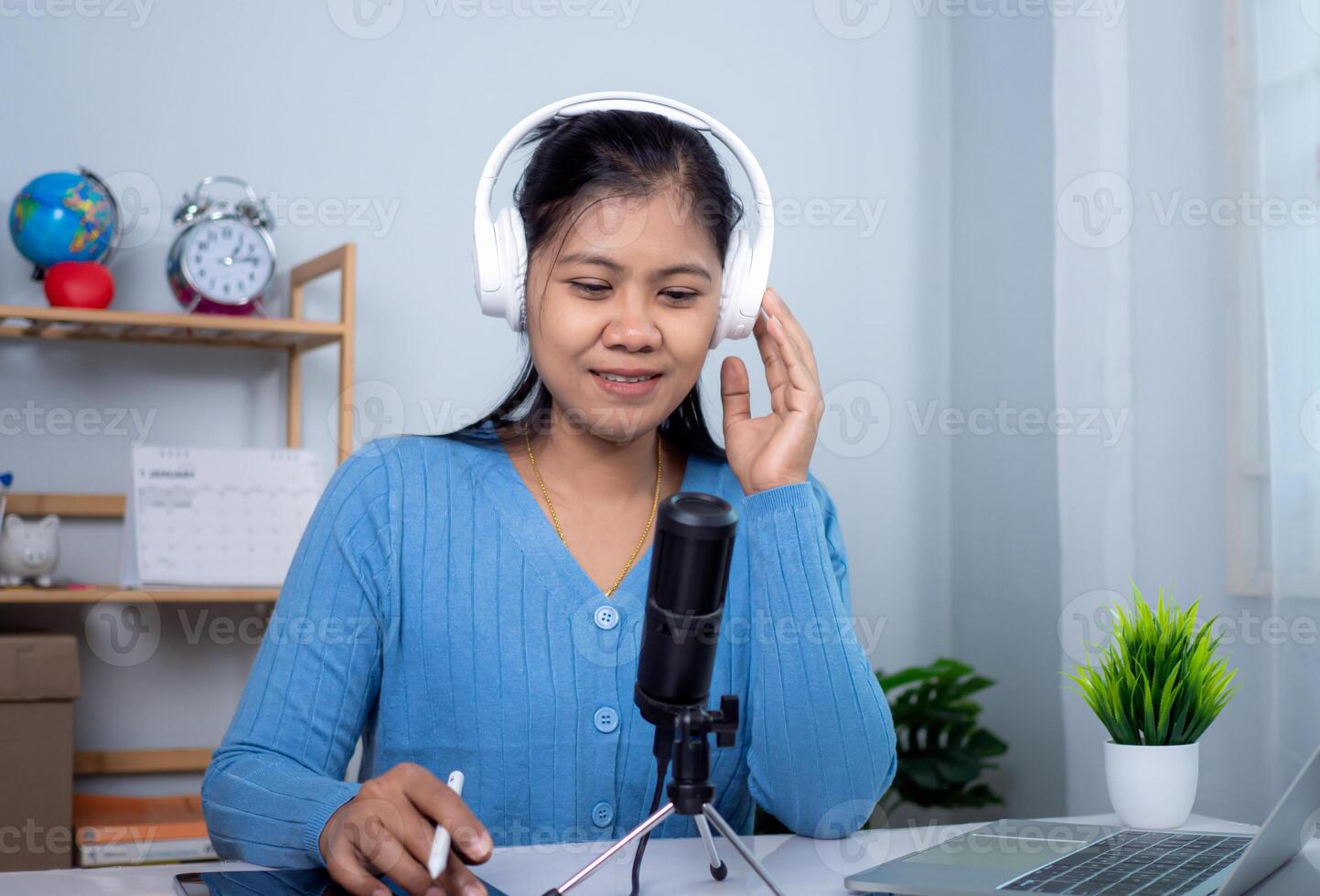 Woman talking into microphone on stand, Content creator concept, Lead on-line communication, Discuss topic, looks at notebook screen, Engaged in streaming, Virtual meeting event, Podcast, Webinar. photo