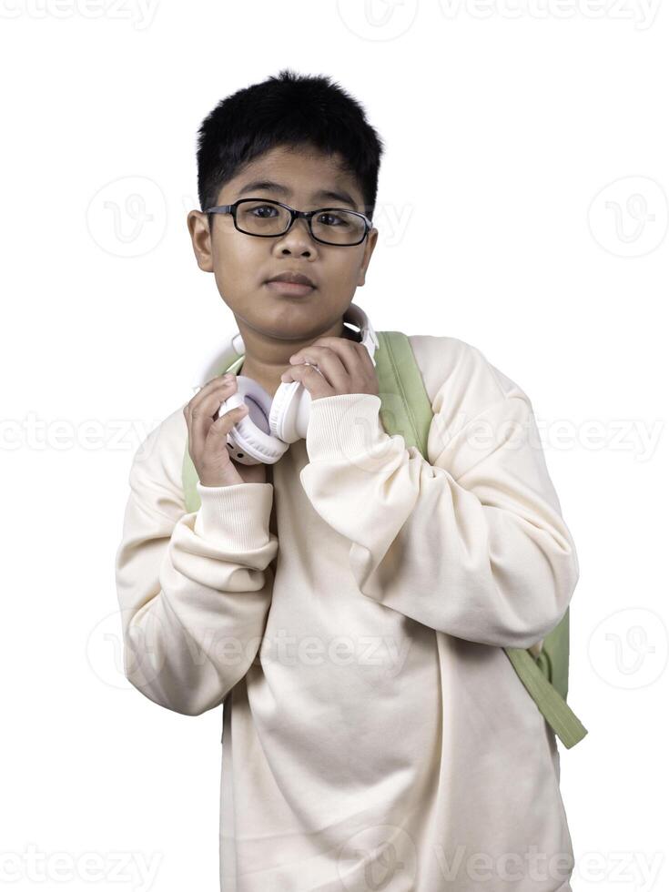 Portrait of boy in casual clothes carry a green bag and white headphones isolated on a white background, The concept of education and way of life. Cute boy posing in casual clothes with clipping part. photo
