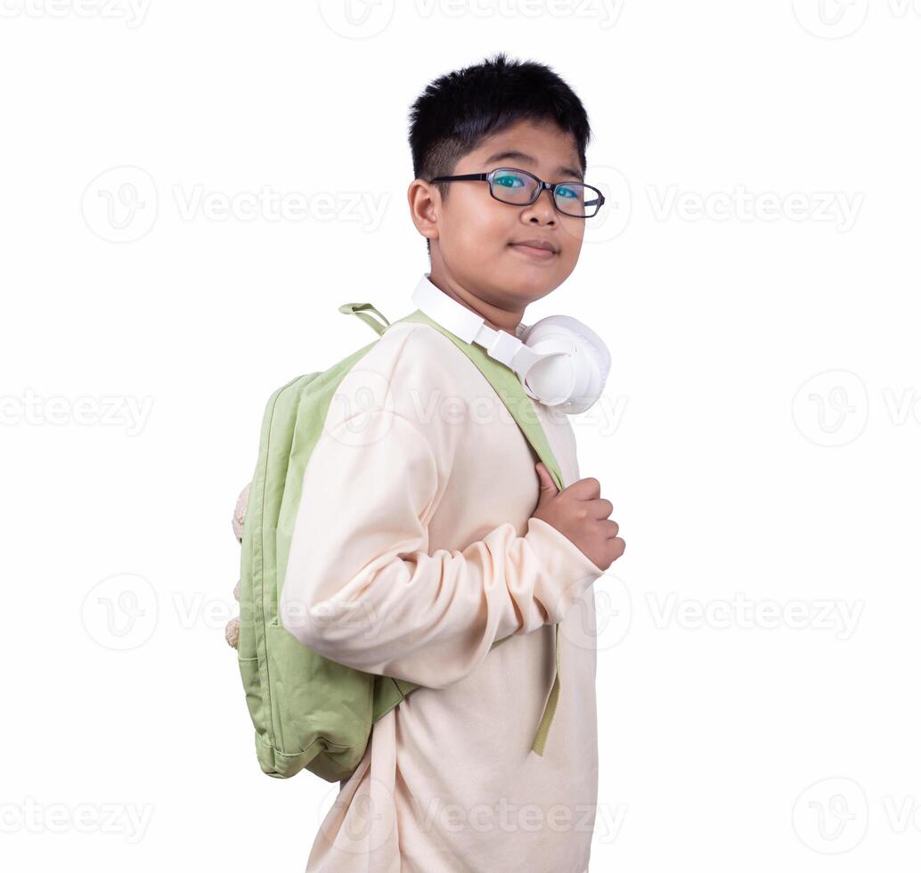 Portrait of school boy in casual clothes carrying a green bag and white headphones isolated on a white background, The concept of education and way of life, Cute boy posing in casual clothes. photo