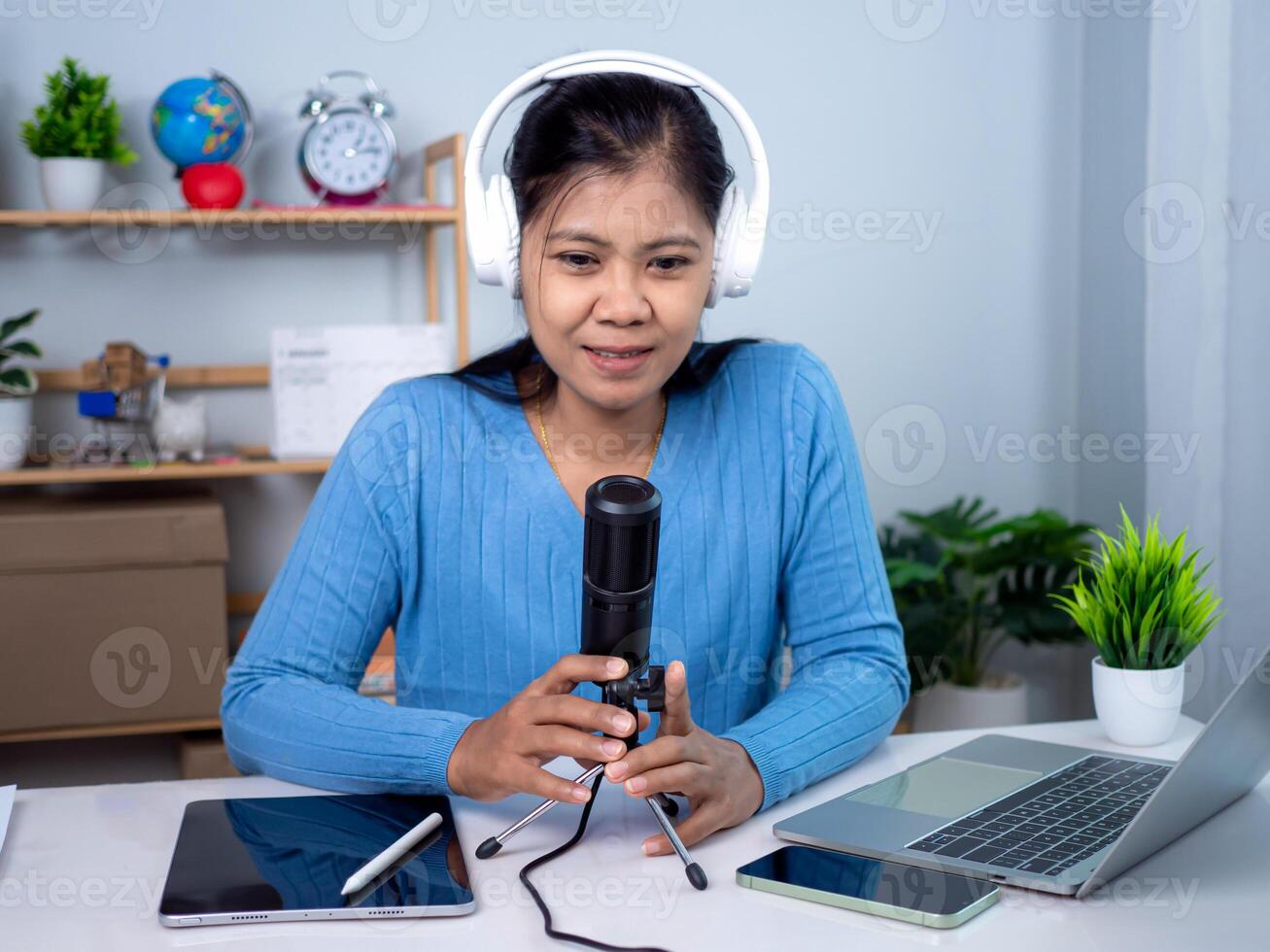 Content creator concept, Woman talking into microphone on stand, Lead on-line communication, Discuss topic, looks at notebook screen, Engaged in streaming, Virtual meeting event, Podcast, Webinar. photo