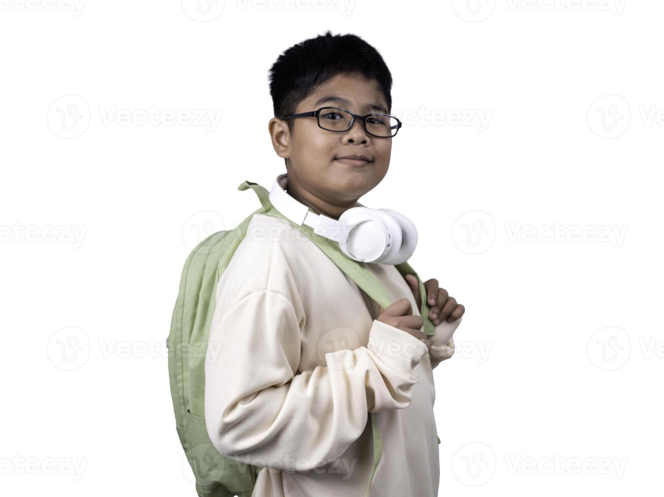 Portrait of boy in casual clothes carry a green bag and white headphones isolated on a white background, The concept of education and way of life. Cute boy posing in casual clothes with clipping part. photo