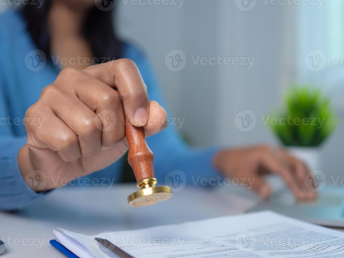 Businesswoman hand stamping with approved stamp on text approved document at desk, Validates and manages business documents and agreements, Approval stamp, Signing on business partner paper to success photo