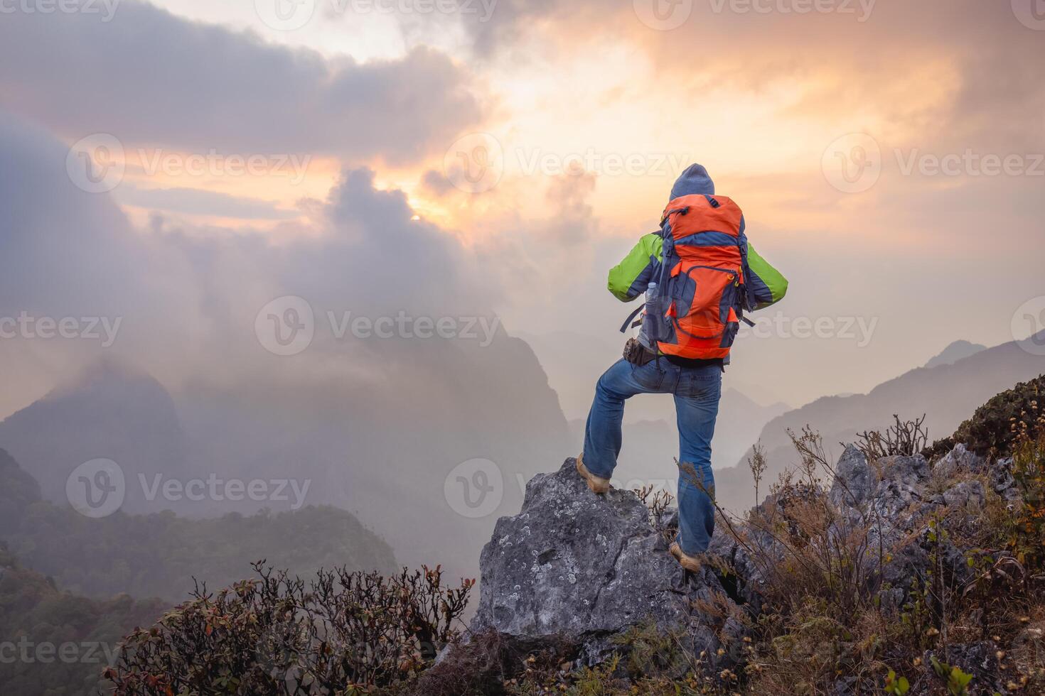 Man hiker on a top of a mountain, hiking in mountains photo
