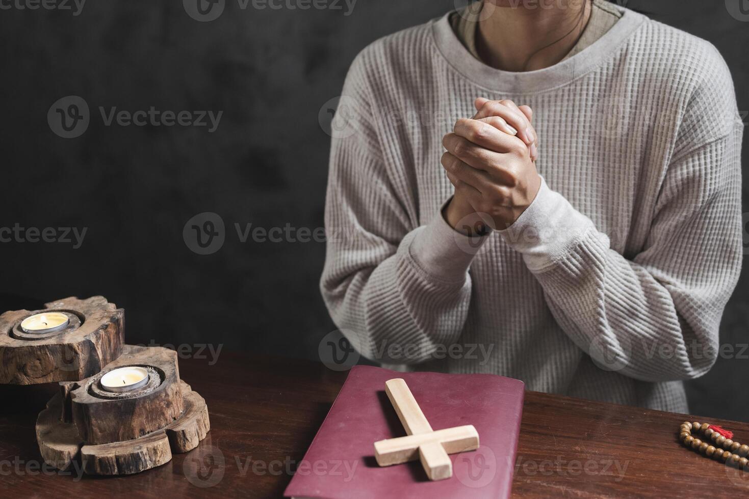 A woman prays with a Bible in a room. her faith unwavering as she prayed and worshiped God, religion concept. photo