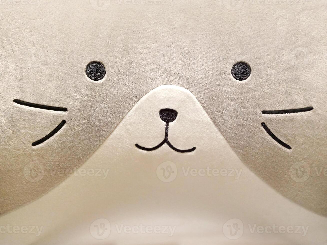 Soft Pillowcase Fabric Texture in the Shape of a Cute cat's Face in Gray photo