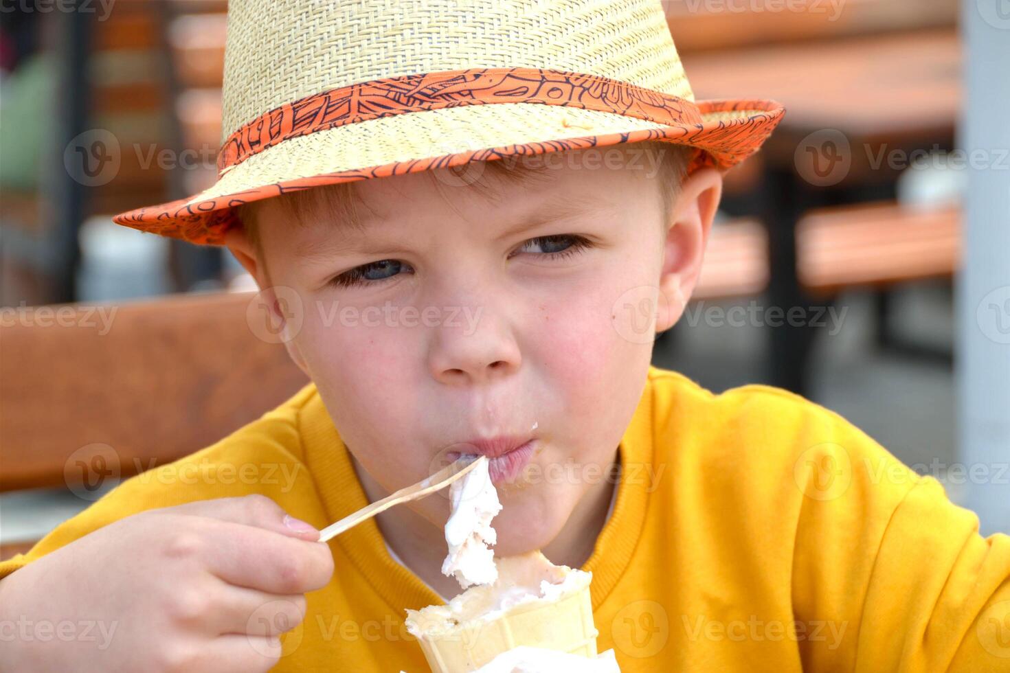Happy child, boy eating ice cream on the beach, enjoying summer, playing. Halkidiki, Greece photo
