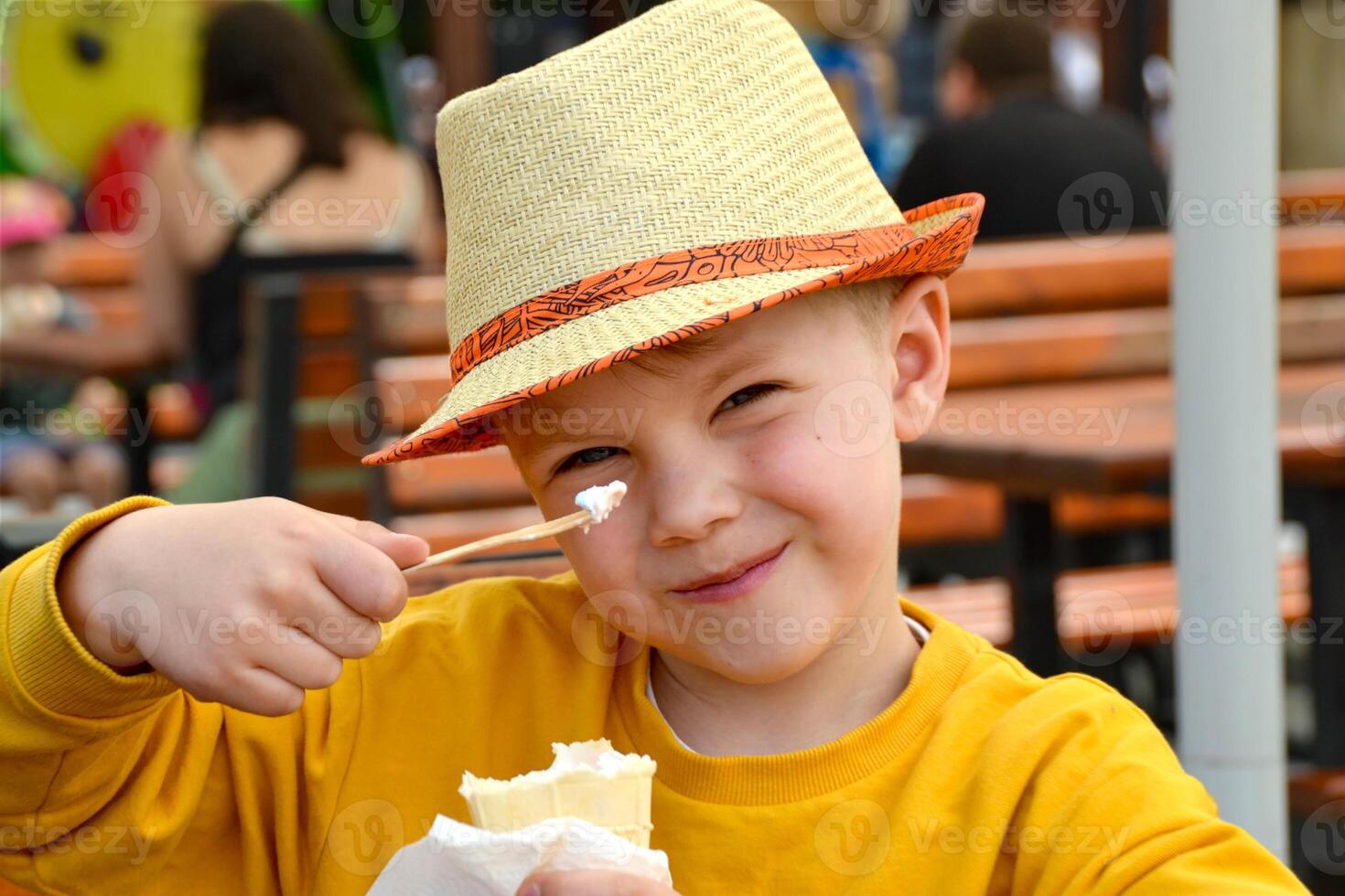 Happy child, boy eating ice cream on the beach, enjoying summer, playing. Halkidiki, Greece photo