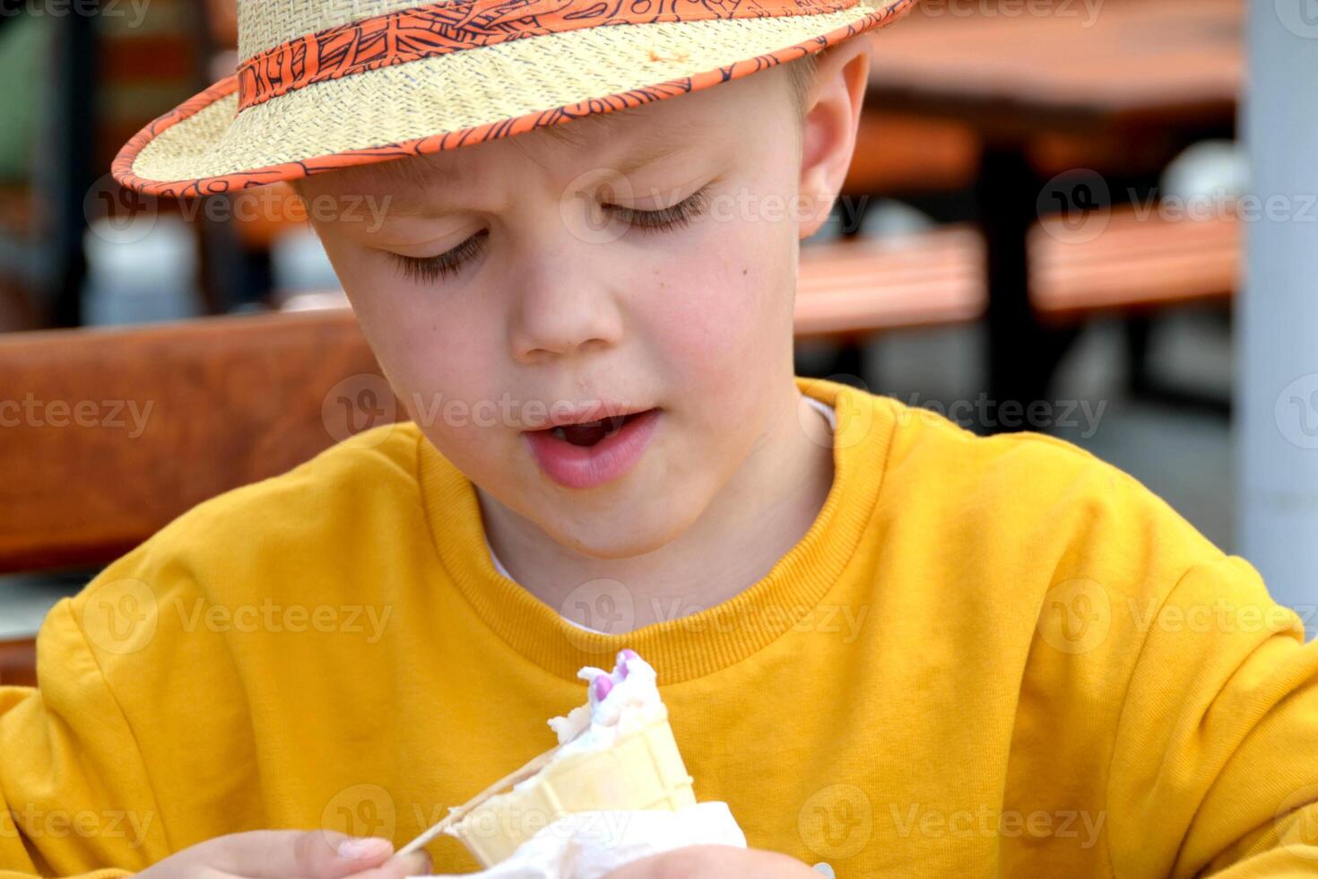Happy child, boy eating ice cream on the beach, enjoying summer, playing. Halkidiki, Greece photo