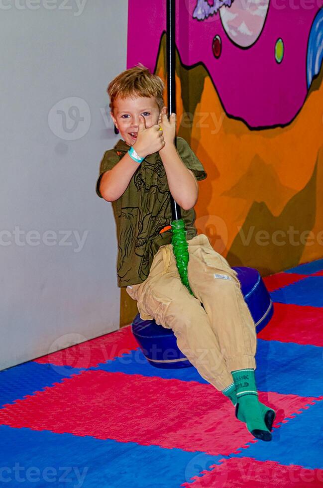 Cute young boy enjoy playing in indoor playground.Concept photo of child