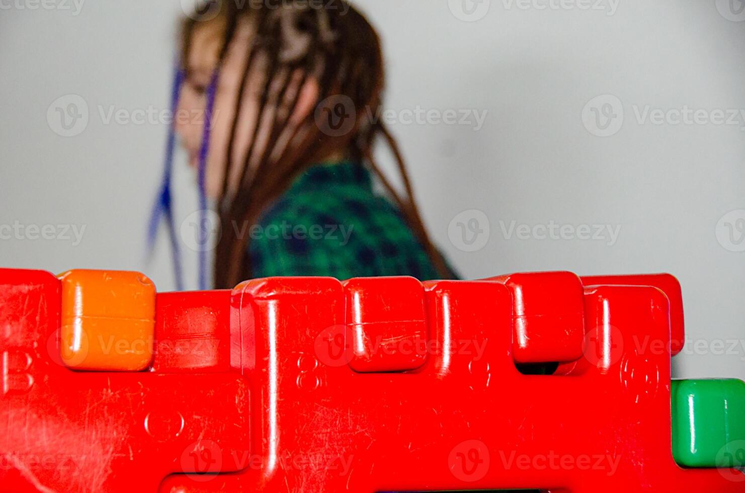 Little girl on the playground with colored plastic balls photo