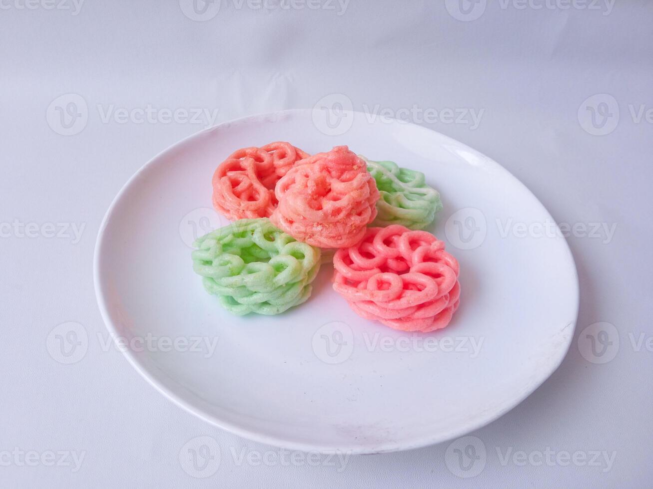 colorful crackers on a plate isolate on white photo