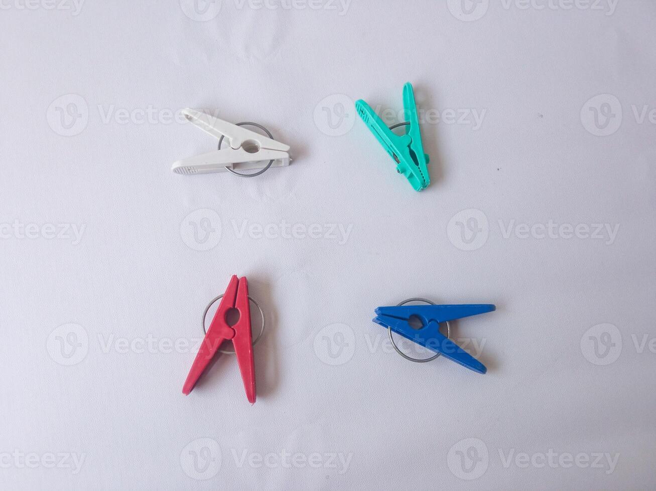 colorful clothes pegs isolate on white photo