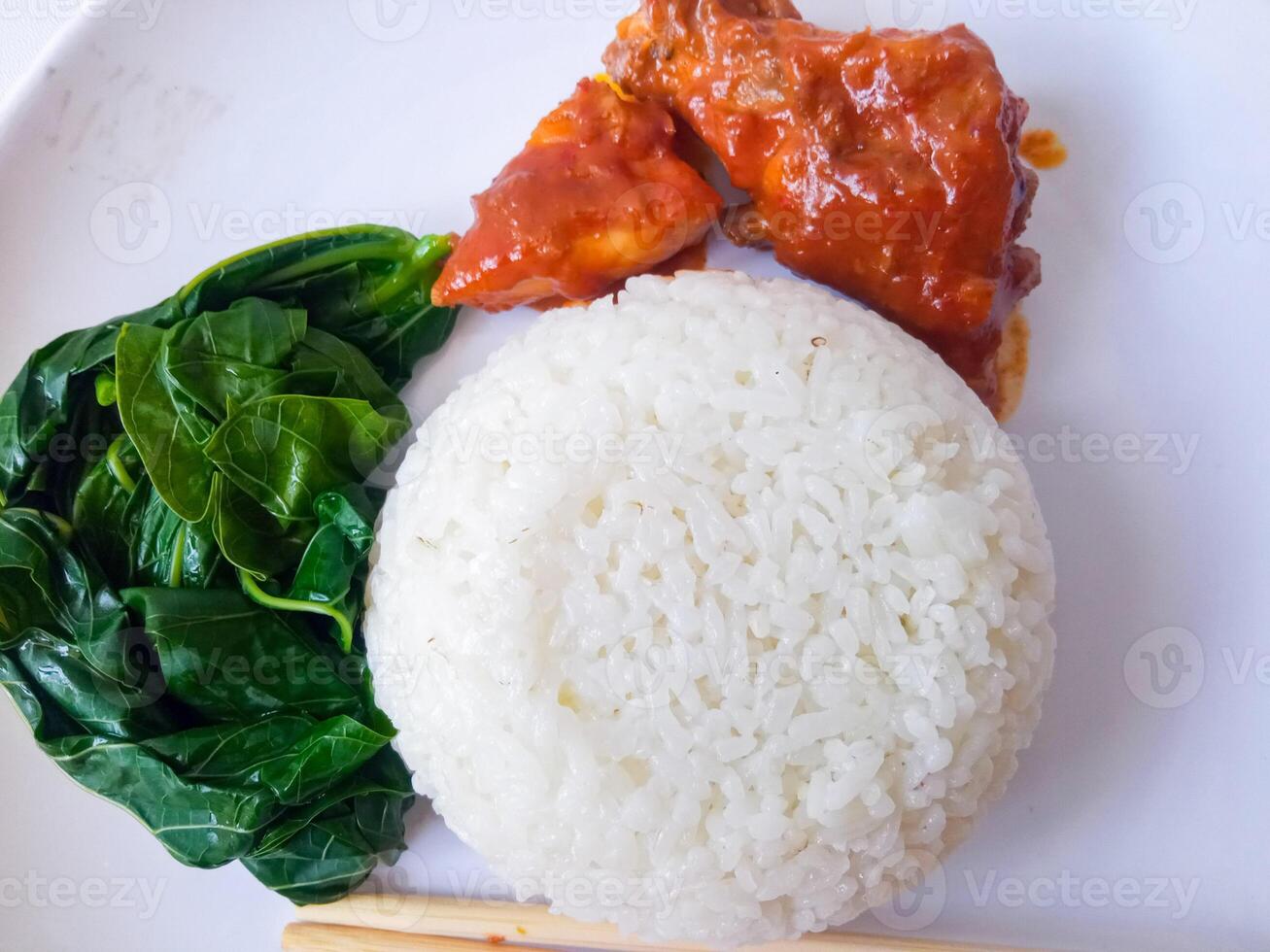 rice with padang rendang chicken side dish and cassava leaf vegetables on a white plate isolate on white photo